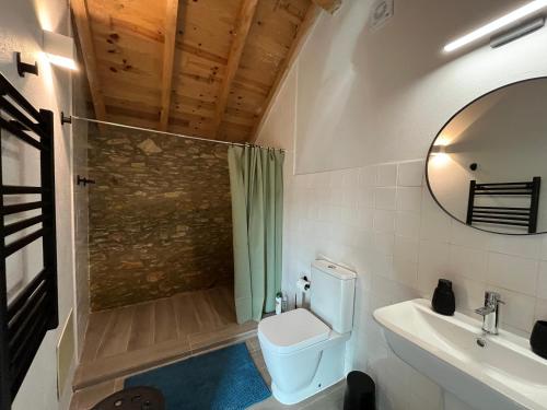 a bathroom with a toilet and a shower and a sink at Casa Abílio - country house in Alvoeira