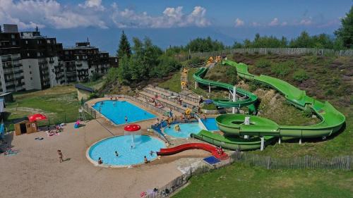 a large water park with two pools and slides at Appartement - Prapoutel - Les Adrets - 7 Laux in Les Adrets