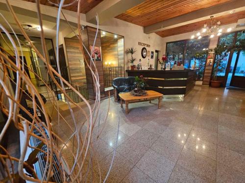 a lobby of a store with a table and a chair at Хотел Свети Трифон in Melnik