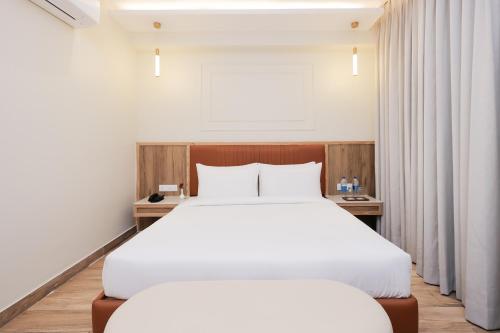 a bedroom with a large white bed and a window at ECKO City Centre Rishikesh in Rishīkesh
