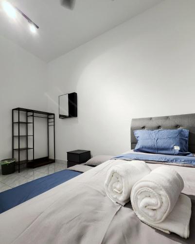 a bedroom with a bed with towels on it at Malacca 3 bedroom Seri Serindit G01 in Malacca