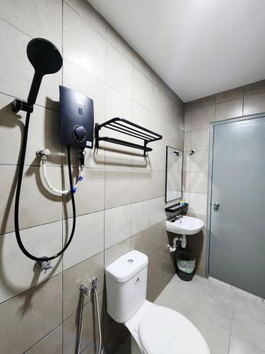 a bathroom with a shower and a toilet and a sink at Malacca 3 bedroom Seri Serindit G01 in Malacca