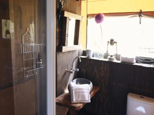 Un baño con inodoro, lavabo y ventana. en Beach Lodge Callantsoog near the Sea, en Callantsoog