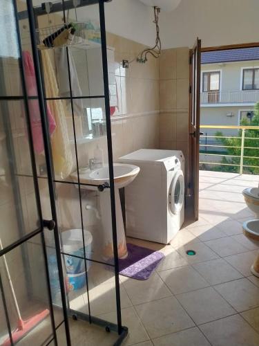 a laundry room with a washer and a washing machine at Karaj Apartment in Tirane
