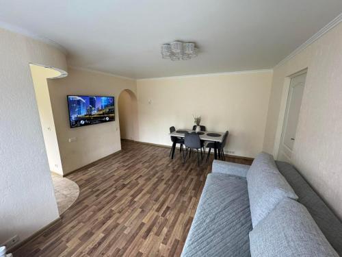 a living room with a couch and a table at Spacious apartment in Jurmala in Jūrmala