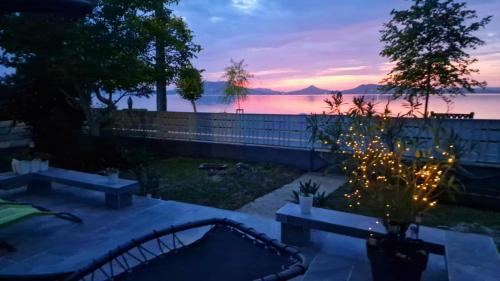 a backyard with christmas lights and a sunset at Sunset Beach House in Fonyód
