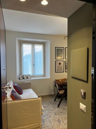 a room with a window and a couch and a table at Apartment Nicole in Menaggio
