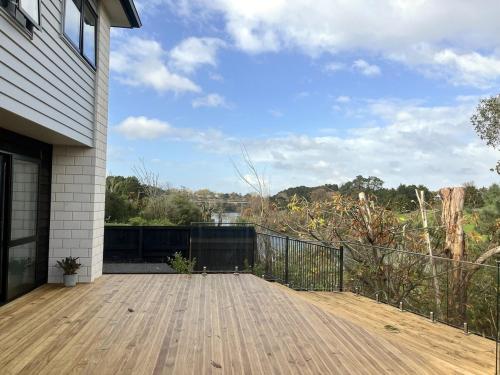 a porch with a wooden deck with a view at 7th Heaven on Waikato River in Hamilton