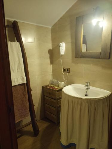 a bathroom with a sink and a mirror at La Cerca in Arcones