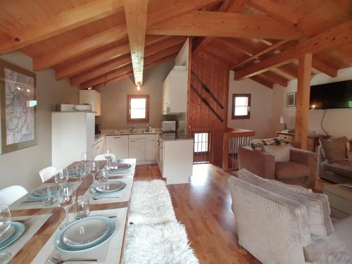 a dining room and kitchen with a table and chairs at Mountain Village Chalet in Saas-Fee