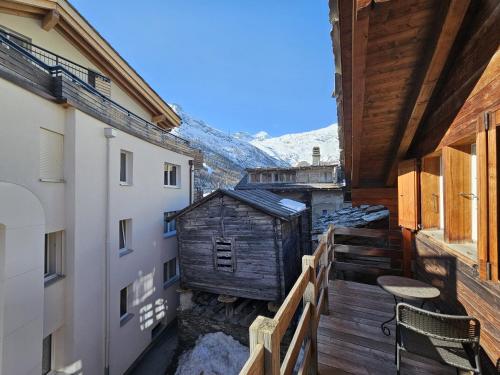 a balcony of a house with a wooden deck at Chalet Renu in Saas-Fee