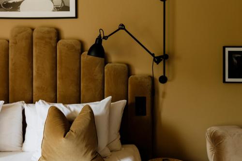a bedroom with a bed with a lamp and pillows at Quality Hotel Carlia in Uddevalla