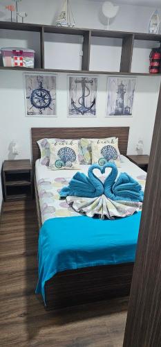 a bedroom with a bed with blue towels on it at Mobile Home Sea Shell Šime, Drage in Drage