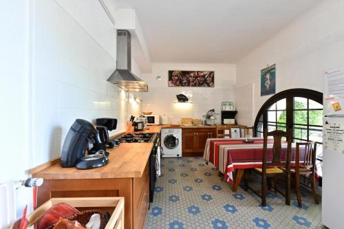 a kitchen with a table and a stove top oven at Bernet in Labastide-Villefranche