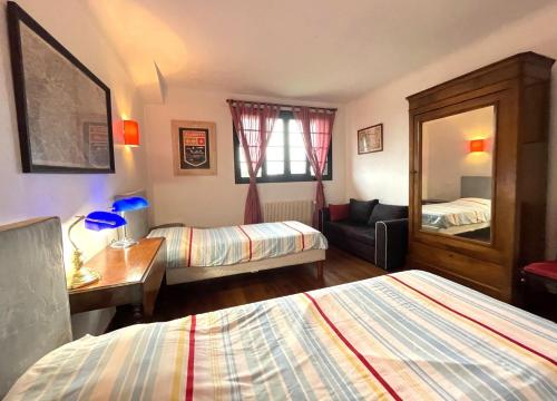 a hotel room with two beds and a mirror at Bernet in Labastide-Villefranche