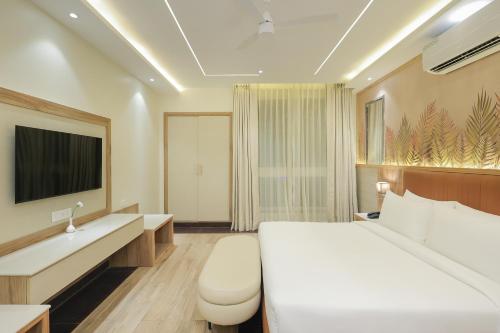 a hotel room with a bed and a sink at ECKO City Centre Rishikesh in Rishīkesh