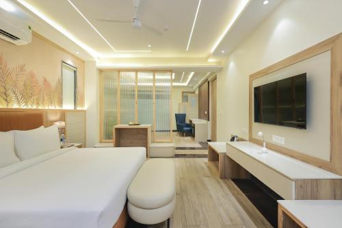 a hotel room with a bed and a desk at ECKO City Centre Rishikesh in Rishīkesh