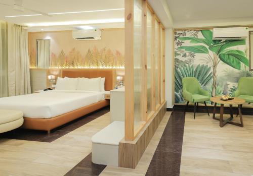 a hotel room with a bed and a table and chairs at ECKO City Centre Rishikesh in Rishīkesh