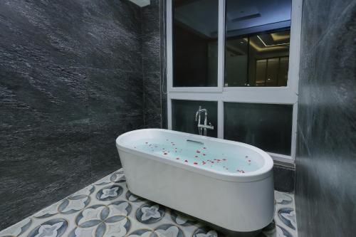 a bathroom with a bath tub with sprinkles on it at ECKO City Centre Rishikesh in Rishīkesh