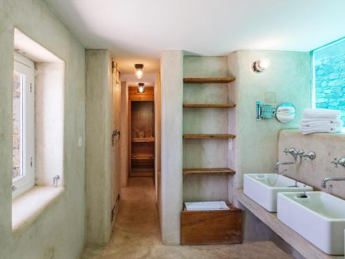 a bathroom with a sink and a tub and a mirror at Villa Levi's in Mykonos
