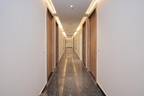 a corridor in a building with wooden walls and a long hallway at ECKO City Centre Rishikesh in Rishīkesh