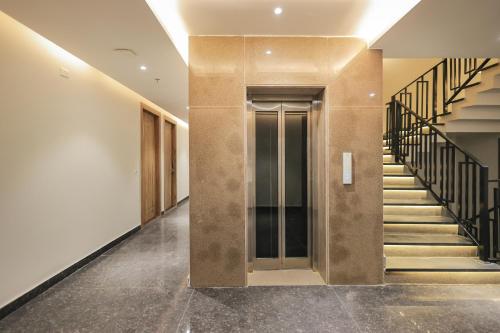 a hallway with stairs and a elevator in a building at ECKO City Centre Rishikesh in Rishīkesh