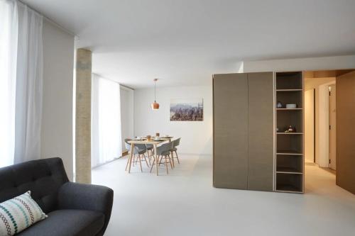a living room with a couch and a table at Contemporary Cosy Central Studio in Nyon - RM8 in Nyon