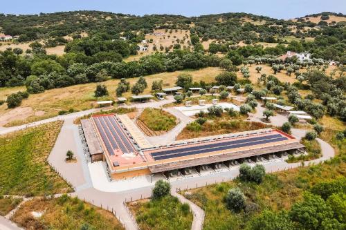 an overhead view of a building with solar panels on it at Gandum Village - Conscious Boutique Hotel in Montemor-o-Novo