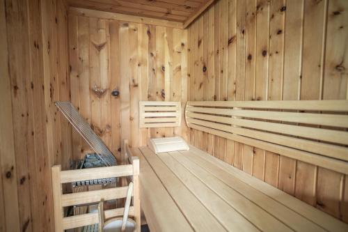 a sauna with wooden walls and wooden floors at Seehotel Bellevue by keyone in Zell am See
