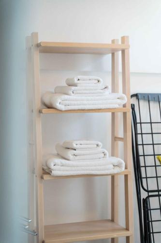 a stack of white towels on a shelf at Villaggio Turistico Priori Malcesine in Malcesine