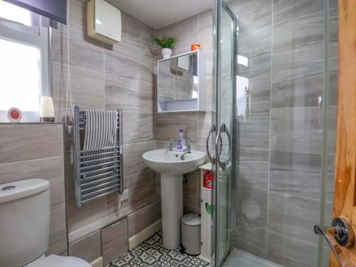 a bathroom with a sink and a toilet and a shower at Sandbay in Bridlington