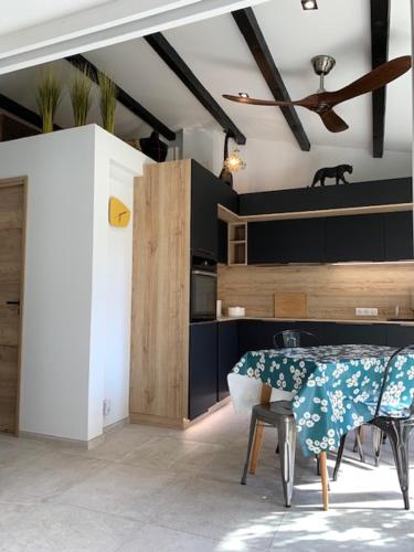 une cuisine avec une table et des chaises et un plafond dans l'établissement Naturiste Cap d'Agde Villa luxe Venus village Sweet Escapade, au Cap d'Agde