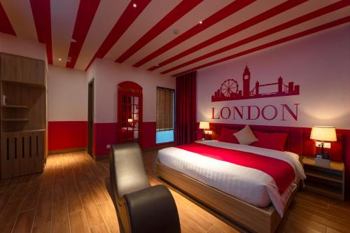 a bedroom with a large bed with a london sign on the wall at Chiic House Hotel - Love Hotel in Nha Trang