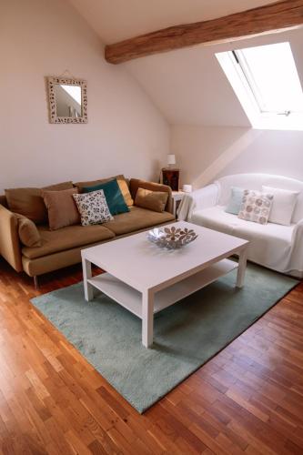 a living room with a couch and a coffee table at Apartment thermale luxeuil in Abelcourt