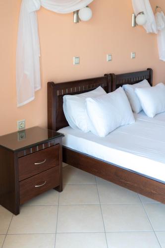 two beds sitting next to each other in a room at Hotel Alexandros in Ammoudia