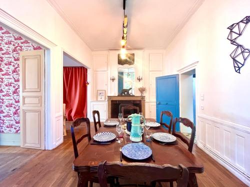 a dining room with a table and chairs at L'imparfait - Maison 5 chambres - Home République in Auxerre