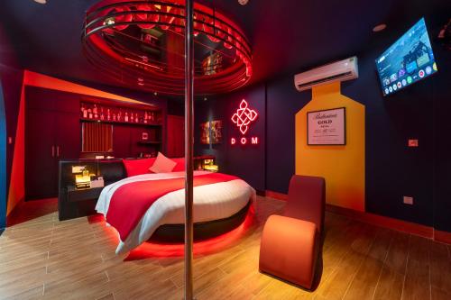 a red room with a bed and a tv at Chiic House Hotel - Love Hotel in Nha Trang