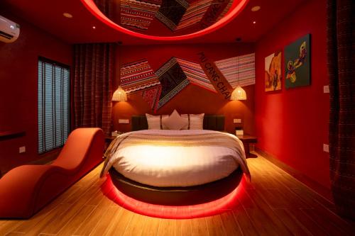 a red bedroom with a bed with a red led lighting at Chiic House Hotel - Love Hotel in Nha Trang