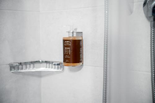 a bottle of soap in a shower stall at Hotel Euròpa Dolomites in Selva di Val Gardena