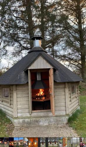 a dog house with a fire in the window at Large Activity House With Free Waterpark And Bowling, in Henne Strand