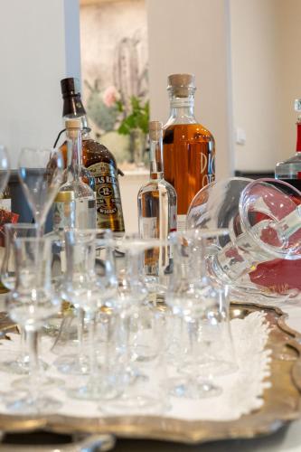 a bunch of wine glasses sitting on a table with bottles at La Sosta Hotel in Vestone