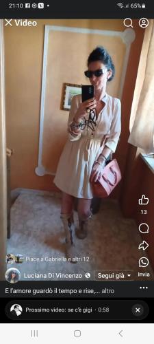 a woman taking a picture of herself in a mirror at Casa Fara in Fara San Martino