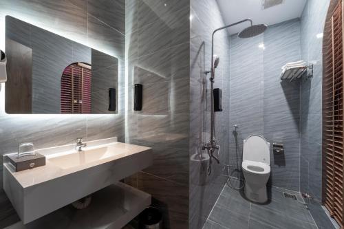 a bathroom with a sink and a shower and a toilet at Chiic House Hotel - Love Hotel in Nha Trang