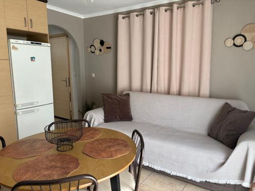 a living room with a couch and a table at Peaceful Nook 2 in Alexandroupoli