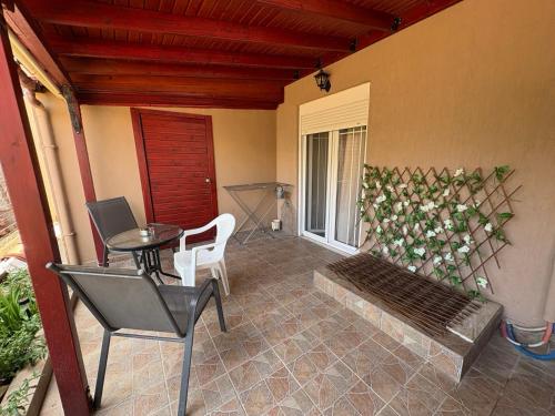 a porch with a bench and a plant on the wall at Peaceful Nook 2 in Alexandroupoli