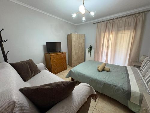 a living room with a couch and a tv at Peaceful Nook 2 in Alexandroupoli