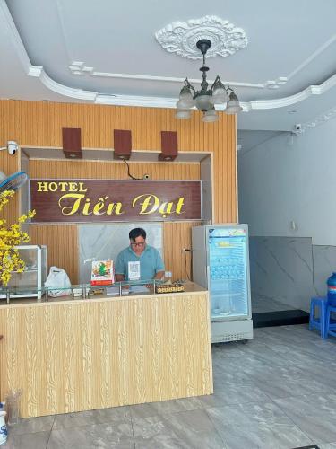 a man is sitting at a hotel sign dj at Tiến Đạt Hotel Vũng Tàu in Vung Tau