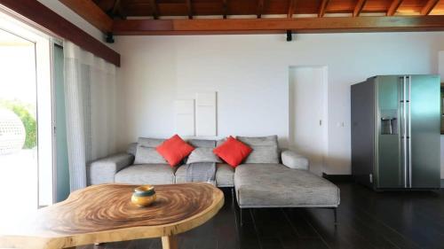 a living room with a couch and a table at Striking Couples Villa Near Toiny Beach in Toiny