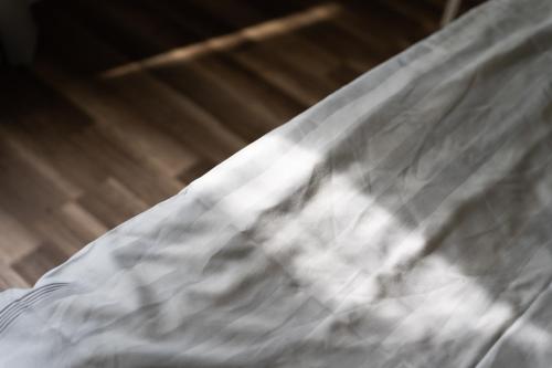a close up of a bed with white sheets at Toftagården Bed and Breakfast in Gnisvärd
