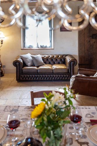 a living room with a couch and a table at L'Oliveta 6, Emma Villas in Gambassi Terme